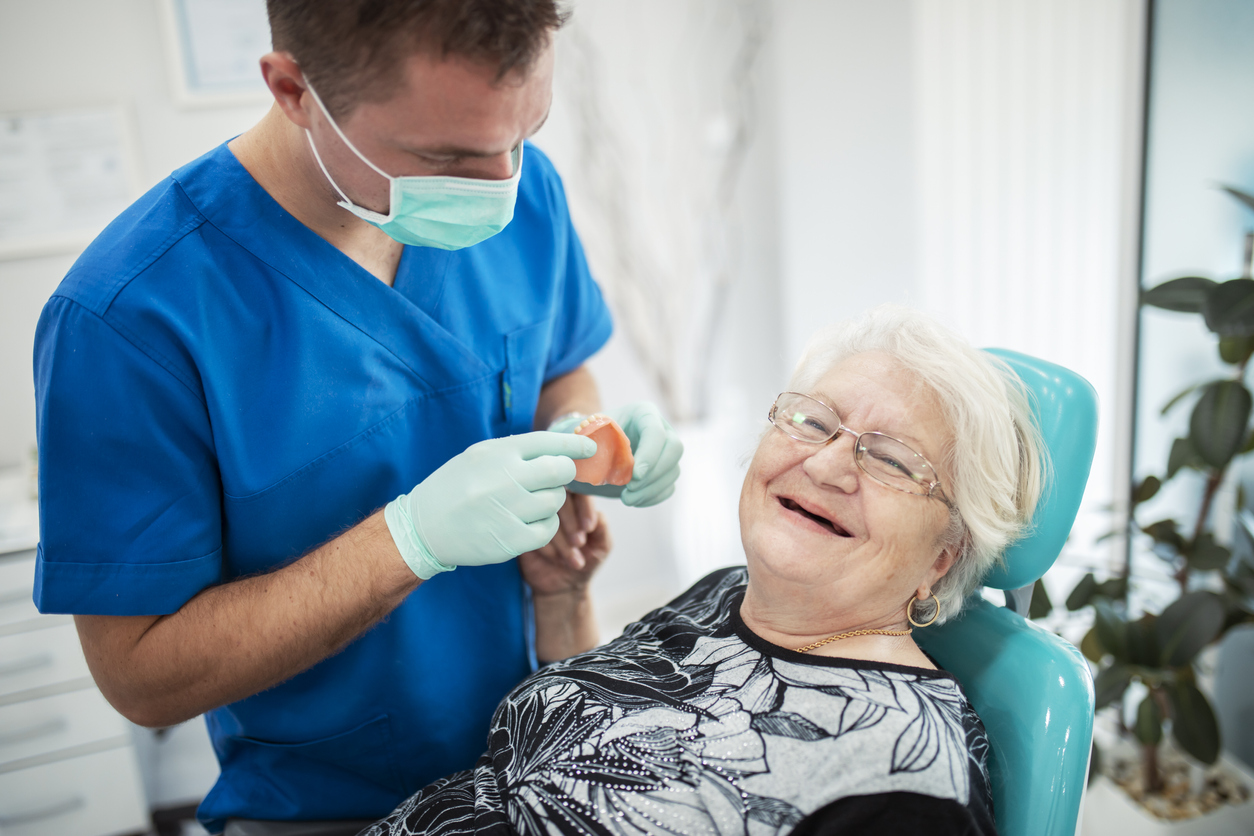 Elderly woman on a review of a dentist, sitting in a chair – Dentaclinic Studi Dentistici